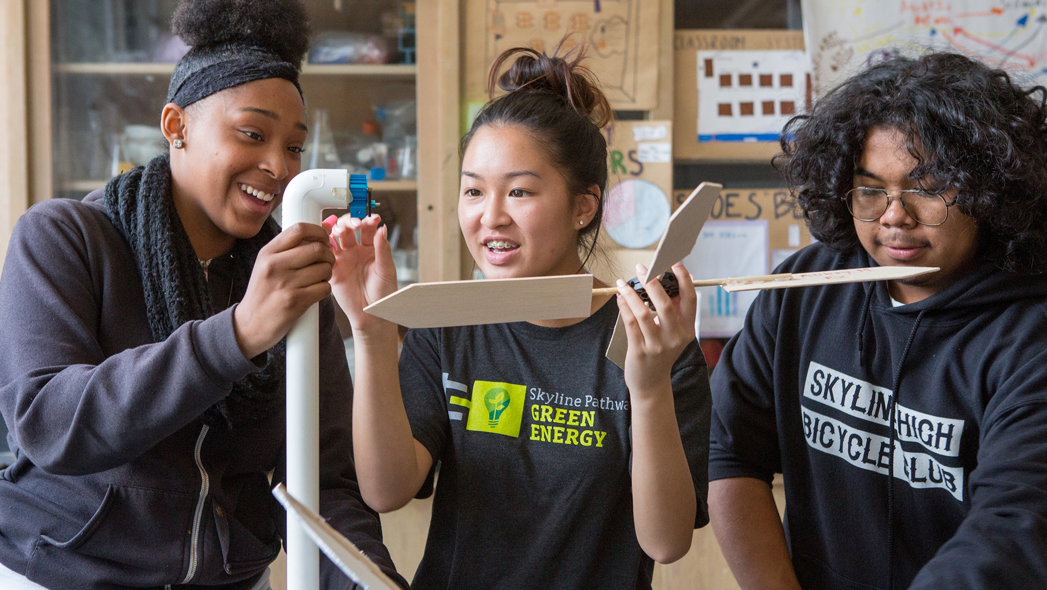 Two high school girls and one high school boy in science lab